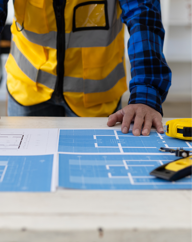 Expert on construction looking at blueprints
